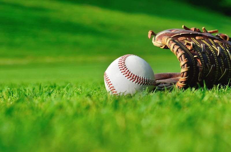 baseball and glove on grass